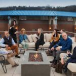 group of friends hanging out on roof of townhouse