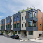 Front view of modern Bauhaus-style townhomes featuring large windows, mixed materials, and rooftop terraces – Buchanan Construction Commercial Asheville NC